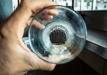 Hand holding an empty beer glass in a conception idea of alcohol