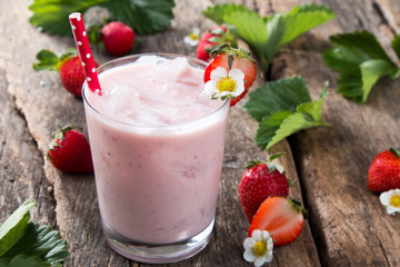 Fresh milk, strawberry on wooden table, assorted protein cocktails with fresh fruits. Natural background.