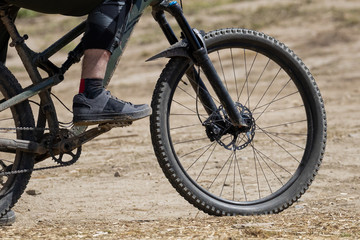 Fototapeta premium Mountain Biker standing with mountain bike waiting to hit the trail.