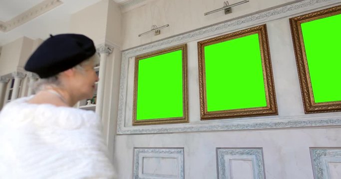 Portrait of elderly woman exploring art pieces in art gallery