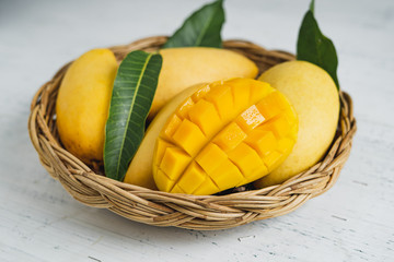 Mango in the basket on White wood background