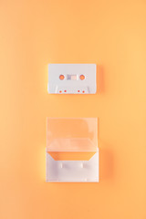 Vintage retro audio cassette on orange background