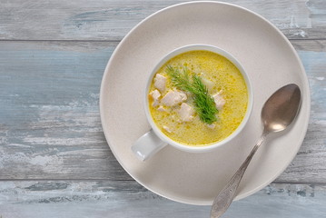 Chicken soup. Hot winter soup with chicken and potatoes. Chowder soup with chicken and potatoes. Fresh creamy soup with chicken and vegetablesin white bowl on the wooden background. Healthy food 