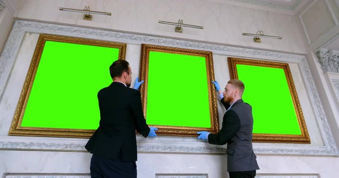 museum staff carrying the picture in storage