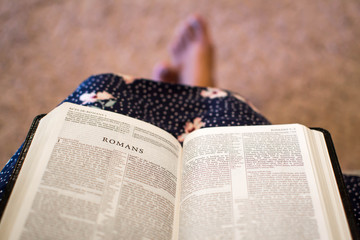 Open bible on female's lap