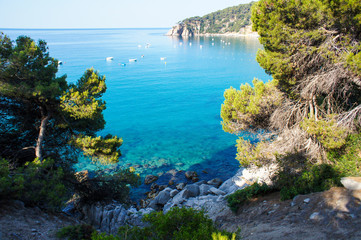 Costa Brava beach. Blue clean water and beautiful beach. Turquoise bay with a crystal water. Summer vacation. Nature in Spain 
