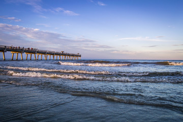 Sunset over Atlantic ocean with pier