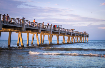 Sunset over Atlantic ocean with pier