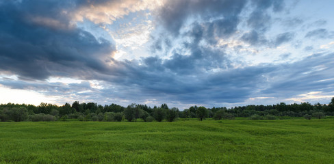 Dramatic sunset on the summer field.