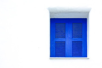 blue windows on white wall santorini style