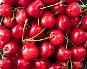 Fresh red cherries. Texture cherries fruits close up. Cherry fruit. Cherries with copy space for text. Top view. Background of cherries.