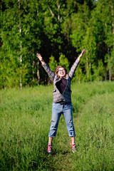 Young beautiful asian girl having fun and jumping in the forest