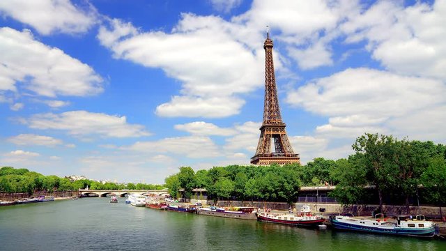Eiffel Tower seen from the Pont de Bir Hakeim bridge in Paris France on a beautiful Spring day with blue sky and white clouds