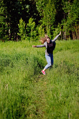 Young beautiful asian girl having fun and jumping in the forest