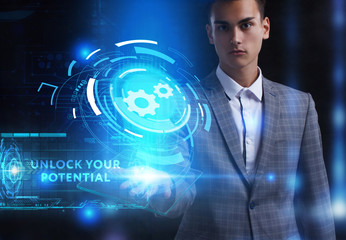 The concept of business, technology, the Internet and the network. A young entrepreneur working on a virtual screen of the future and sees the inscription: Unlock your potential