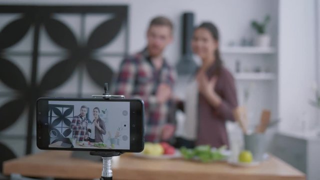 health blog, young couple of vloggers broadcast live on healthy nutrition while preparing useful foods from vegetables and greens according to diet plan with dietary supplements at cuisine - Powered by Adobe
