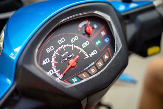 Close-up on motorcycle or bike speed meter console. Selected focus at some number on the gauge.