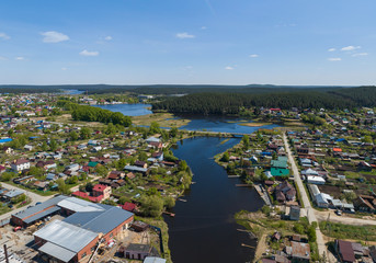 Sysert city. River and houses. Aerial. Summer day