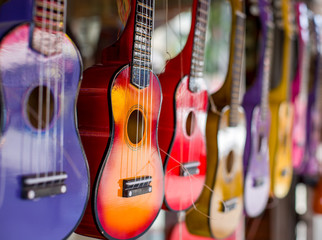 Multi-colored guitars. Little guitars of different colors. The picture was taken on the open aperture. One guitar in focus the rest is blurred.