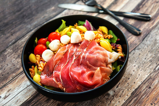 Salad Made With Cooked Pasta, Mixed Green Salads, Cherry Tomatoes, Mozzarella Cheese And Smoked Ham Served With Accompaniment