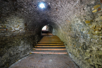 Novi Sad, Serbia June 13, 2019: Up the stairs through the tunnel. Stone stairs climb to clock tower in Novi Sad Petrovaradin Fortress, Serbia