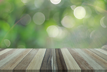 Naklejka na ściany i meble Wood table top on green bokeh abstract background - can be used for display or montage your products ,Clipping Path