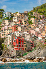 Fototapeta na wymiar Colorful houses along the coastline of Cinque Terre area in Riomaggiore, Italy