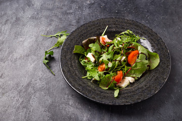 Healthy vegetable salad of fresh tomato, onion, and sesame on plate. Diet menu. Top view.