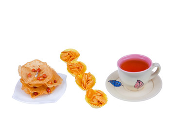 Tea cup , rempeyek and honey corn flake cookies  on white background