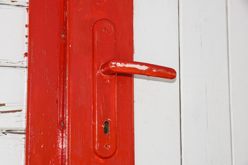 Red color wooden door with brass bolt