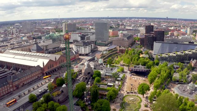 Aerial view of the Tivoli Gardens amusement park with people, visitors, attractions and rides. Urban view of the city of Copenhagen in Denmark, Europe