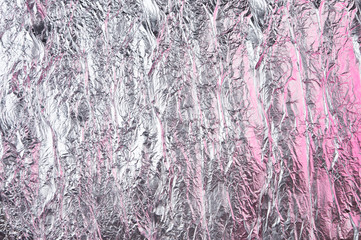 Abstract crumpled foil background. Grunge photo background. Pink shadows
