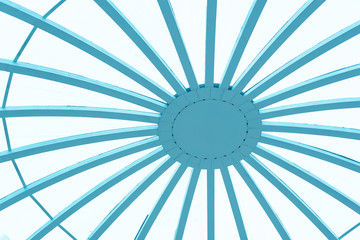 Transparent ceiling made of glass and wood. Abstraction The ceiling is round of plywood and polycarbonate close-up. Photo.Ceiling in the roof structure of wood and blue glass.