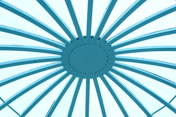 Transparent ceiling made of glass and wood. Abstraction The ceiling is round of plywood and polycarbonate close-up. Photo.Ceiling in the roof structure of wood and blue glass.