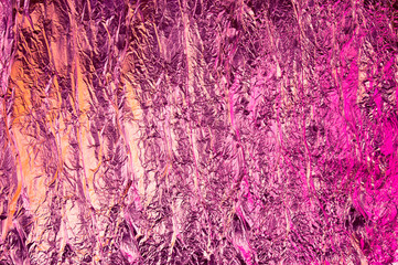 Abstract crumpled foil background. Grunge photo background. Neon colors. Pink and orange colors