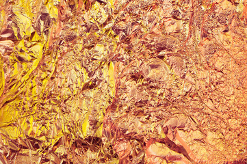 Abstract crumpled foil background. Grunge photo background. Bright yellow and orange colors