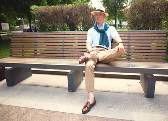 Fototapeta premium The guy is sitting on the bench style casual 