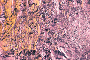 Abstract crumpled foil background. Grunge photo background.Peach and violet colors