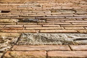 An stone wall of a building from the ground prespective looking up. brick wall