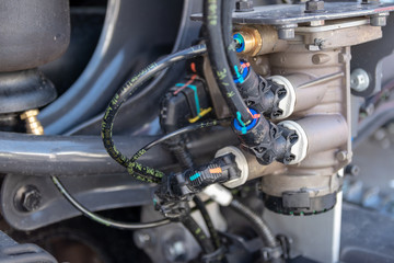 Hydraulic hoses, tube connections, wires on a truck