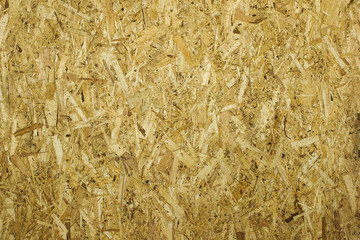 OSB boards are made of brown wood chips sanded into a wooden background