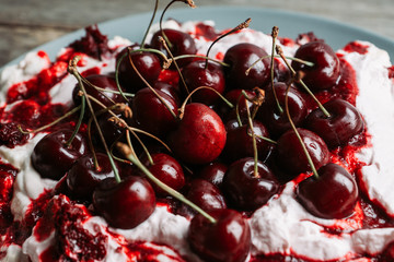 Cherry dessert with whipped cream and meringue cream. Selective focus. Shallow depth of field.