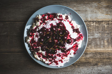 Cherry dessert with whipped cream and meringue cream. Selective focus. Shallow depth of field.