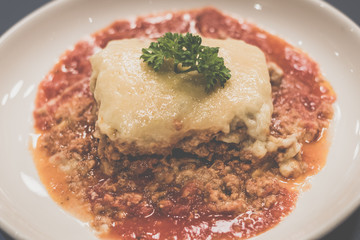 Chicken Lasagne Layers of thick pasta smothered with minced chicken, tomato sauce and cream