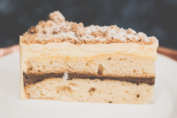 Jaffa Cake Vanilla pound cake sandwiched between rich chocolate mousse, orange jam and mousse.ine, topped with almond butter crumble