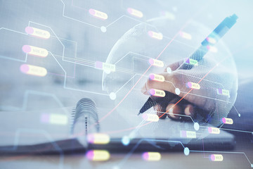 Double exposure of hands making notes with world map hologram and data theme icons. Concept of global computer data.