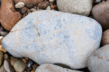Gray blue stone by the river on a summer day