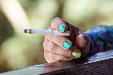 close up of young woman smoking a cigarette