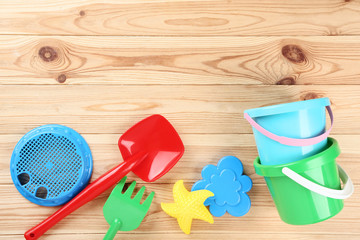 Beach toys on brown wooden table