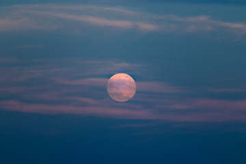 Full moon with clouds at sunset